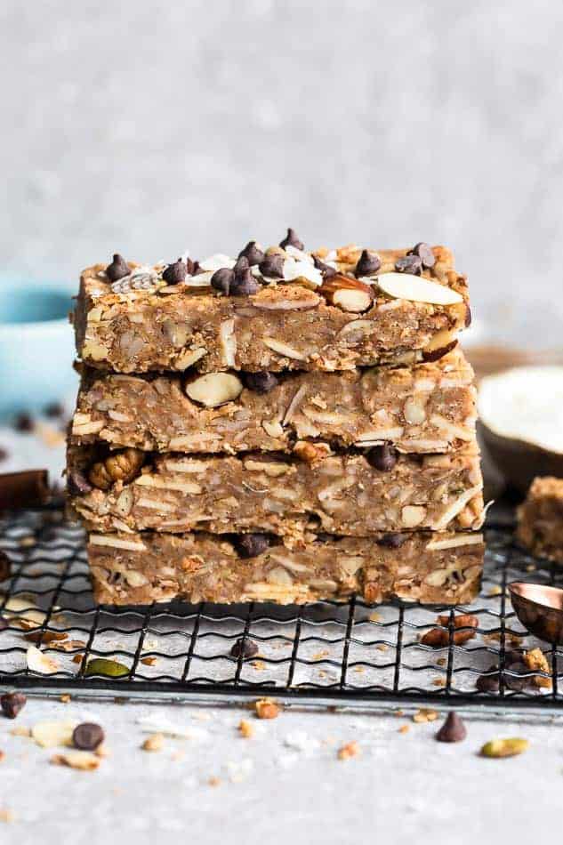 Four peanut butter granola bars stacked on top of each other on a cooling rack