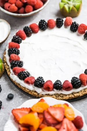 This Healthy Fruit Pizza makes the perfect healthy and extra special breakfast, brunch or dessert. Best of all, it's so easy to make in less than 30 minutes with your favorite fresh fruit, a gluten free granola crust and Vanilla Greek yogurt. Perfect for Mother's Day, Father's Day, Fourth of July, barbecues, potlucks or any other shower or party for spring and summer!