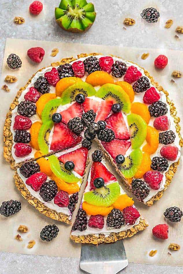 This Healthy Fruit Pizza makes the perfect healthy and extra special breakfast, brunch or dessert. Best of all, it's so easy to make in less than 30 minutes with your favorite fresh fruit, a gluten free granola crust and Vanilla Greek yogurt. Perfect for Mother's Day, Father's Day, Fourth of July, barbecues, potlucks or any other shower or party for spring and summer!