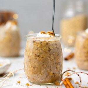 Side view of Gingerbread Overnight Oats in a jar with a spoon
