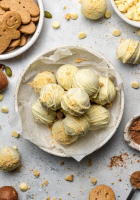 Overhead view of a pile of gingerbread truffles in a white bowl