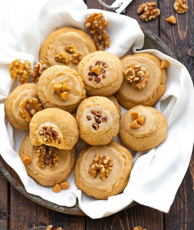 Top view of a pile of vegan maple cookies on a plate with a napkin