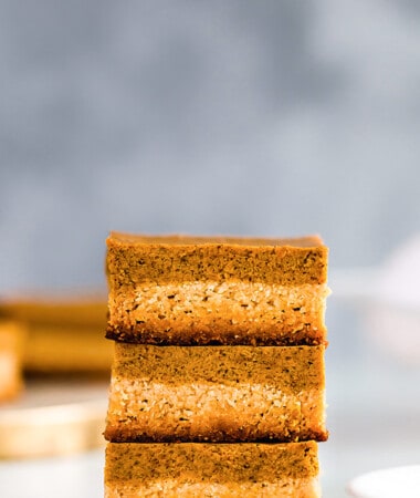 Side view of three keto pumpkin pie bars stacked on top of each other