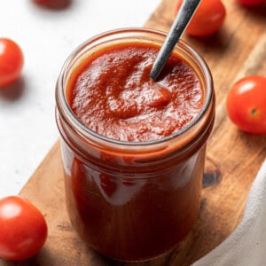 45 degree angle of keto ketchup in a jar with a spoon in the jar