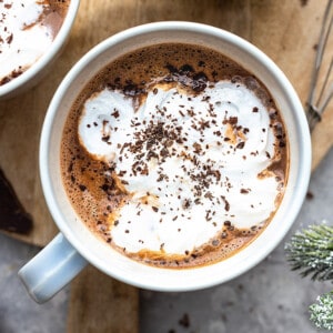 Close-up view of dairy free hot chocolate with vegan whipped cream in a mug