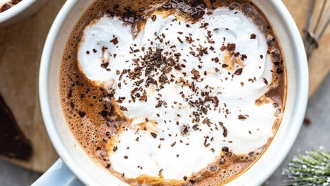 Close-up view of dairy free hot chocolate with vegan whipped cream in a mug