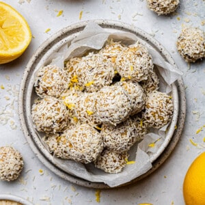 Overhead view of a pile of lemon bliss balls in a white bowl