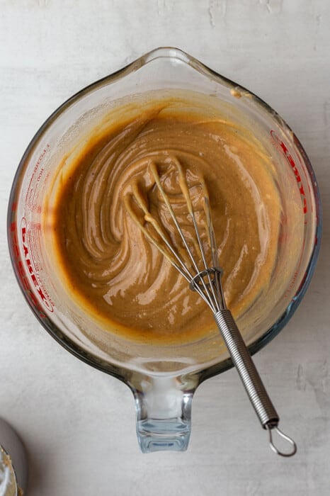 Mixing bowl of peanut butter filling with a whisk
