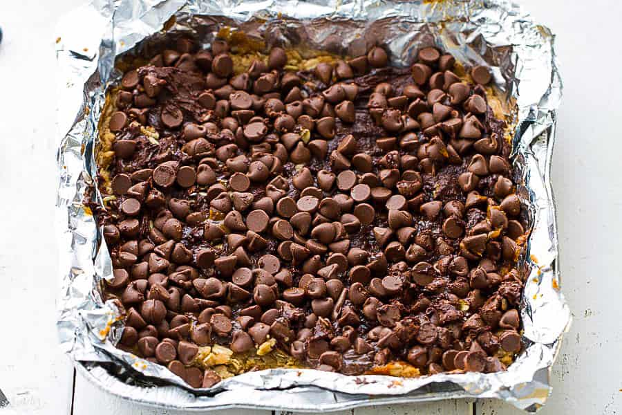 Chocolate chip layer of Pumpkin Oatmeal Bars in a foil lined pan