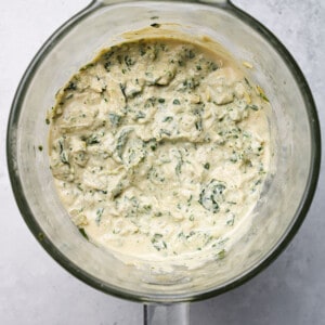 Blended nutritional yeast, miso, cashews, spinach, aritchokes and coconut cream in a blender