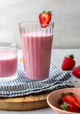 Side view of one strawberry milkshake in a glass