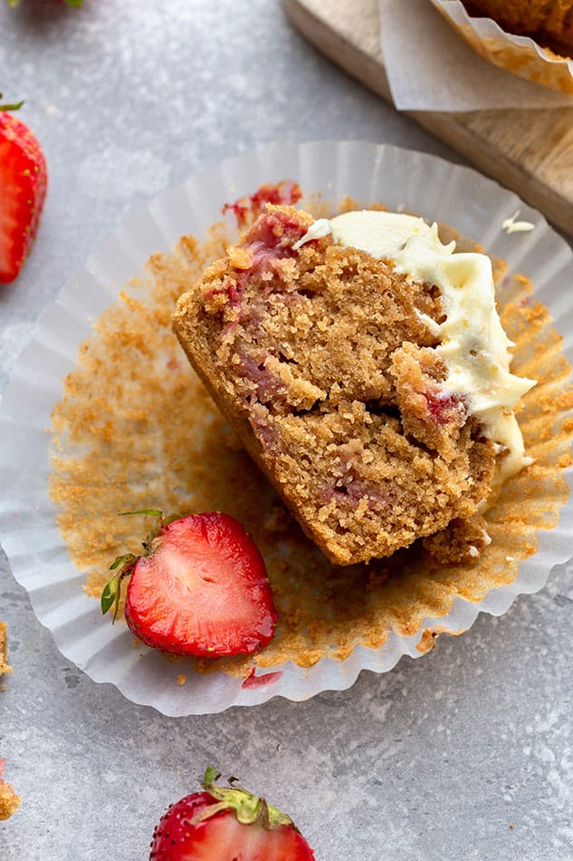 Overhead image of strawberry muffin with bite taken out of the muffin.