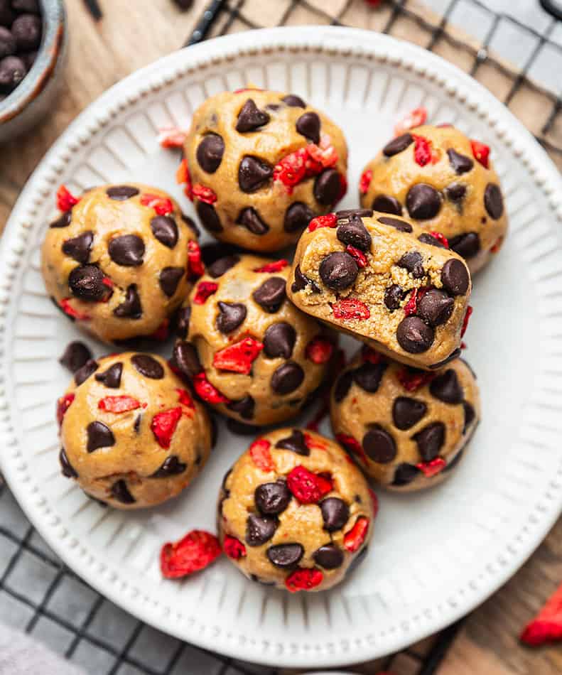 Overhead view of Strawberry Protein Balls with chocolate chips on a white plate