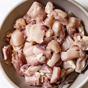 Top view of raw cubed chicken in a grey bowl