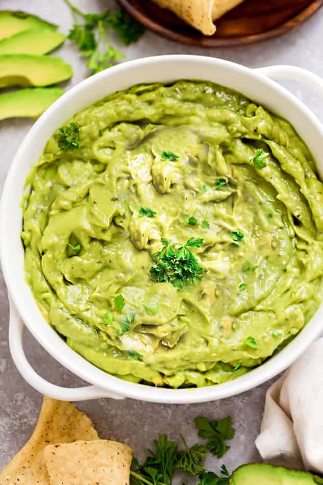 Homemade Guacamole - this quick and simple recipe is the perfect easy party dip with tortilla chips or along with tacos or by the spoonful. Best of all, only 6 ingredients to make for your next Mexican-inspired meal.
