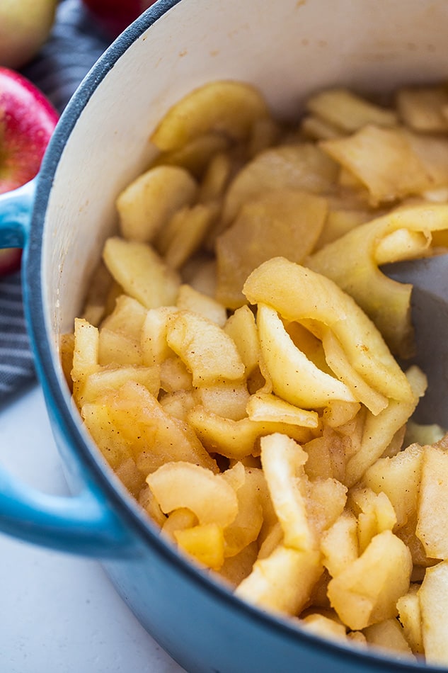 Close-up view of sliced cooked apples in a blue pot