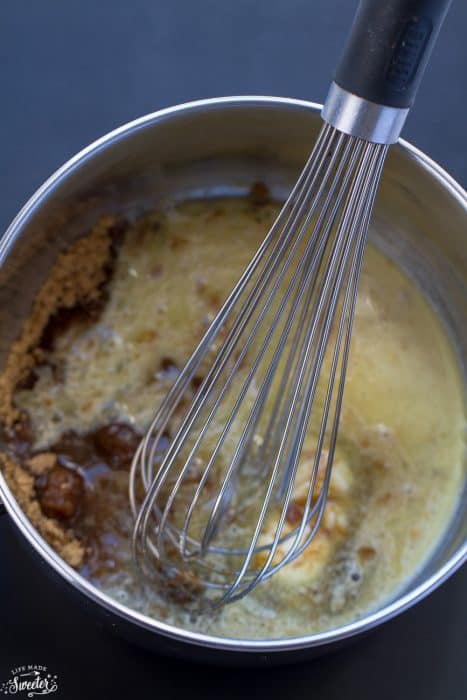 Homemade Caramel Sauce ingredients in a saucepan with a whisk