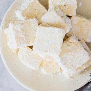 Close-up top view of a pile of vegan marshmallows on a white plate