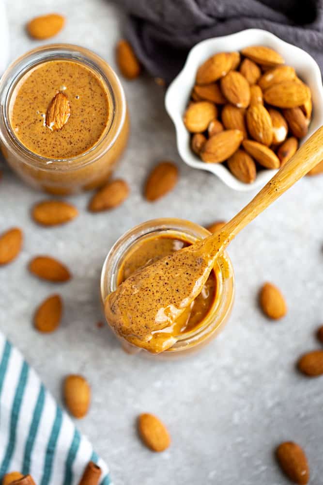 Top view of homemade peanut butter in a jar with a spoon