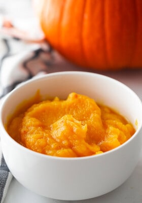 Homemade pumpkin puree in a white bowl