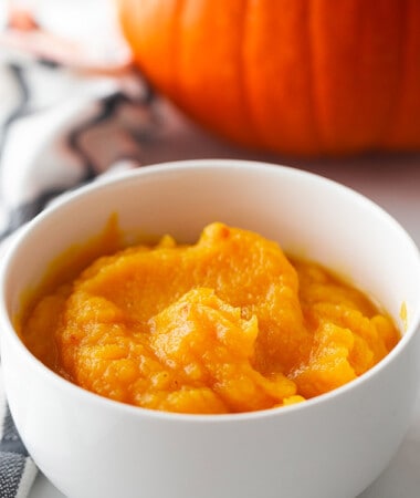 Homemade pumpkin puree in a white bowl