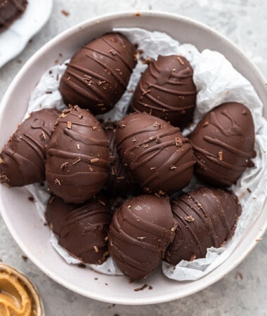 A grey bowl filled with 10 healthy chocolate peanut butter eggs