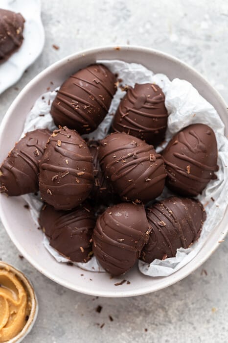 A grey bowl filled with 10 healthy chocolate peanut butter eggs