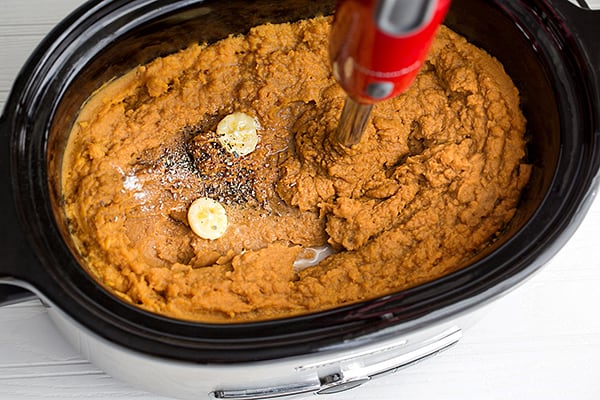 Close up top view of cooked mashed sweet potatoes in a slow cooker