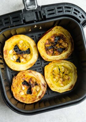 Top view of cooked spaghetti squash rings in an air fyrer basket