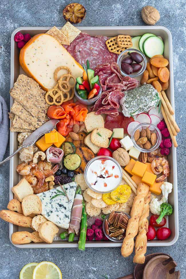 A full cheese board built on a baking sheet