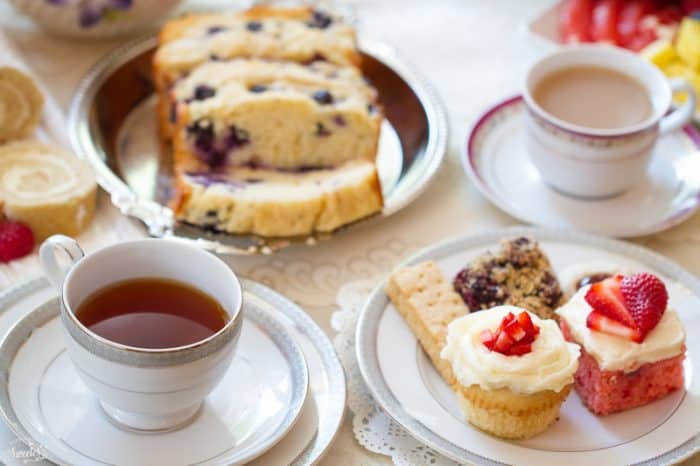 Cups of tea and treats on a table for a tea party