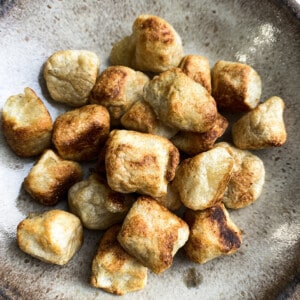 Close-up top view of the best cauliflower gnocchi on a beige plate
