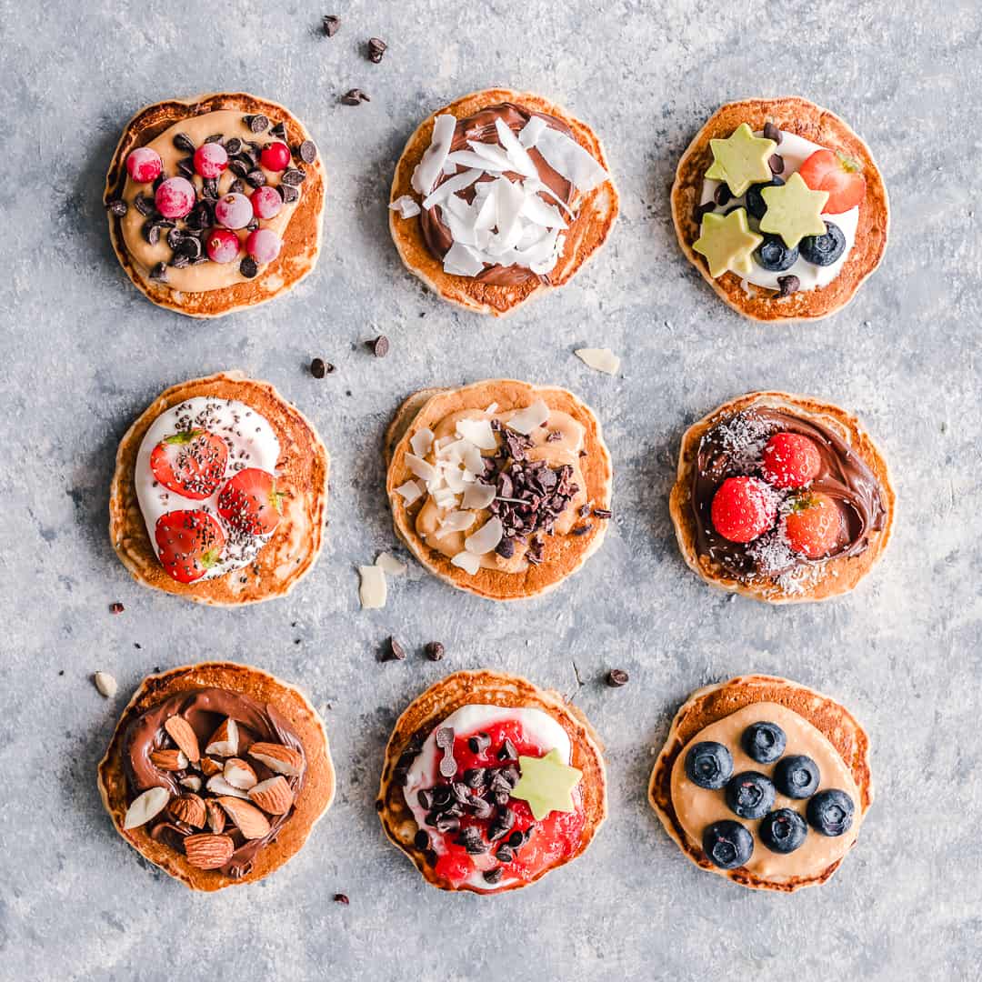 Top view of 9 fluffy pancakes with different toppings