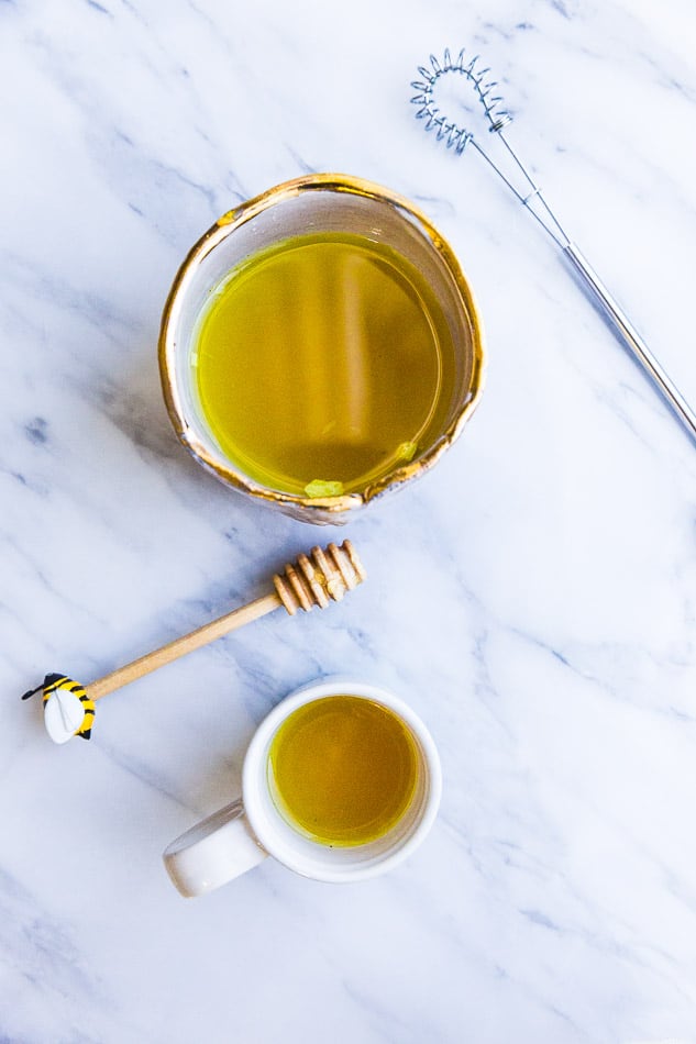 Top view of two cups with immune boosting shots with whisk