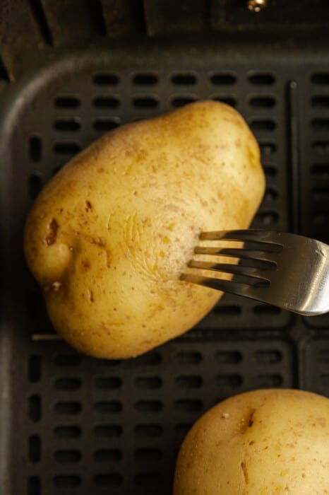 A fork poking a potato