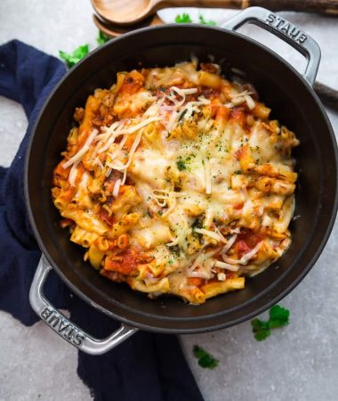 An entire batch of baked ziti in a grey cast-iron dutch oven.