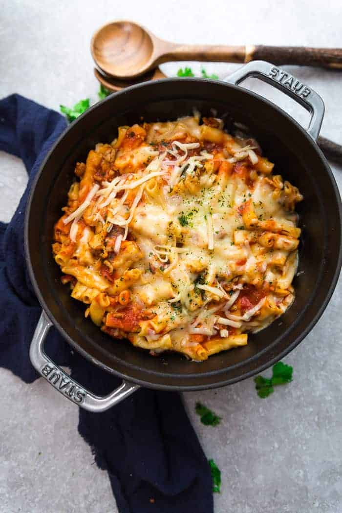 An entire batch of baked ziti in a grey cast-iron dutch oven.