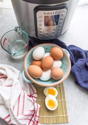 A Bowl of Hard Boiled Eggs Next to an Instant Pot and a Measuring Cup