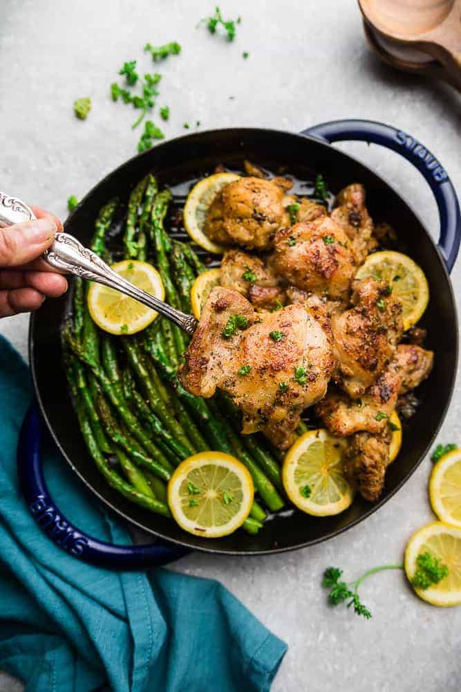 Overhead view of Lemon Garlic Chicken with asparagus and lemon slices