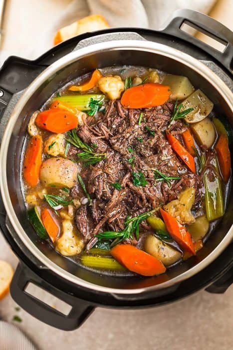 A Pressure Cooker Filled with Chuck Roast Beef and Vegetables