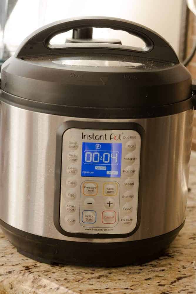 An Instant Pot on a Counter Set to 4 Minutes of Cook Time