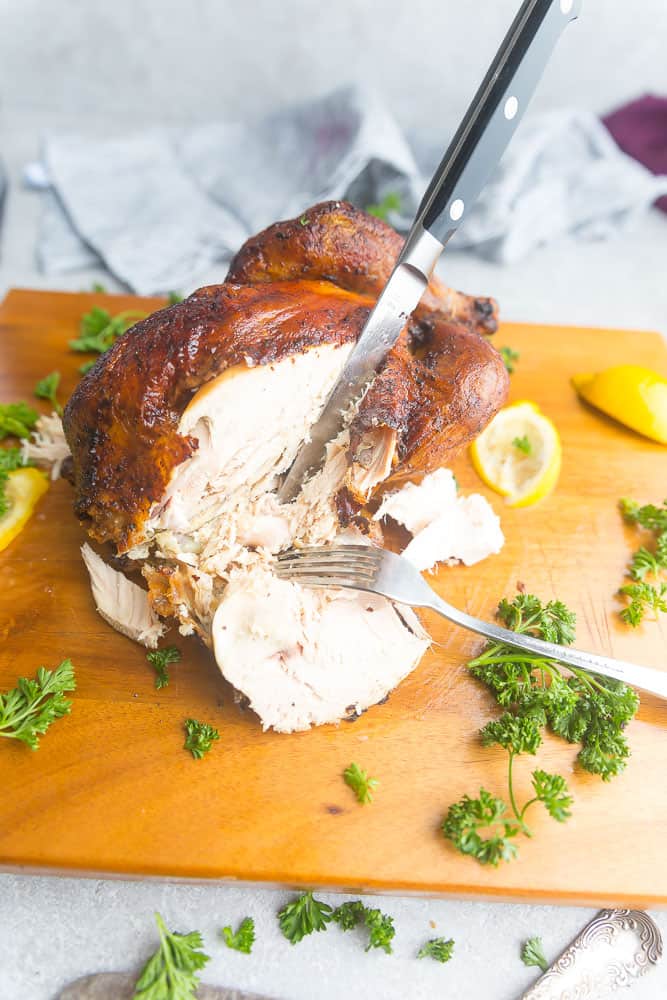 Instant Pot Whole Rotisserie Chicken being sliced on a cutting board