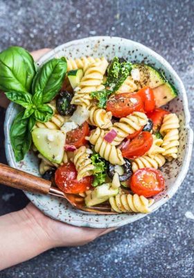 This Easy Italian Pasta is the perfect side dish for summer barbecues, potlucks, parties and cookouts. Best of all, you can customize the add-ins with what you have on hand. This recipe includes cherry tomatoes, zucchini, olives, feta cheese, onions, chopped kale and some fresh herbs like parsley and basil. A homemade Italian dressing makes this even more delicious!
