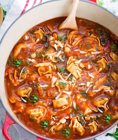This delicious recipe for Italian Sausage Tortellini Tomato Soup is the perfect comforting soup for busy weeknights! Best of all, it's so easy to make and packed with with the most amazing flavors. Made with cheese tortellini, Italian sausage, arugula and tomatoes. Hearty, filling and easy to customize with your favorite greens or vegetables for a nutritious lunch or dinner.