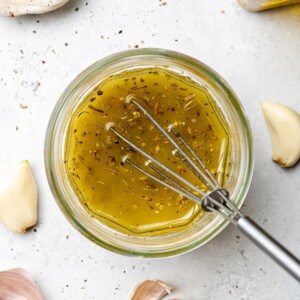 Overhead view of lemon vinaigrette in a jar with a whisk