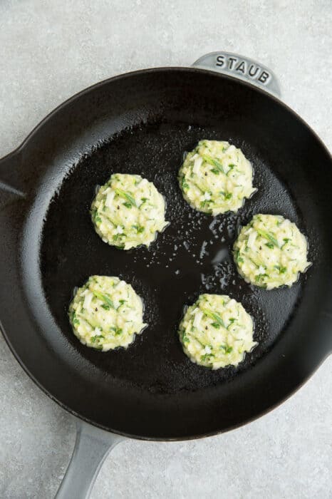 Top view of zucchini fritter batter in a cast iron pan
