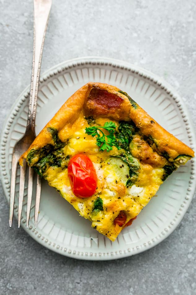 Top view of low carb breakfast egg casserole on a white plate with a fork