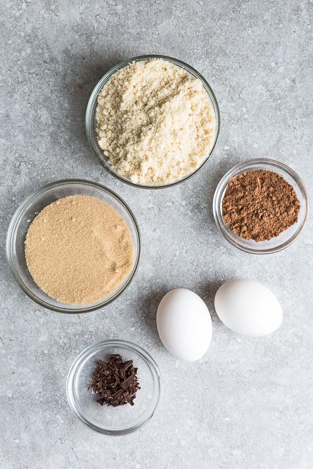 Top view of ingredients to make sugar free keto brownies on a grey background