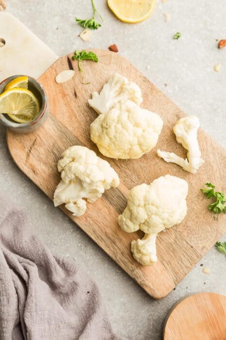 Top view of fresh cauliflower on a wooden cutting board
