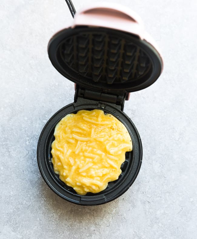 Top view of chaffle batter in a Dash mini waffle iron